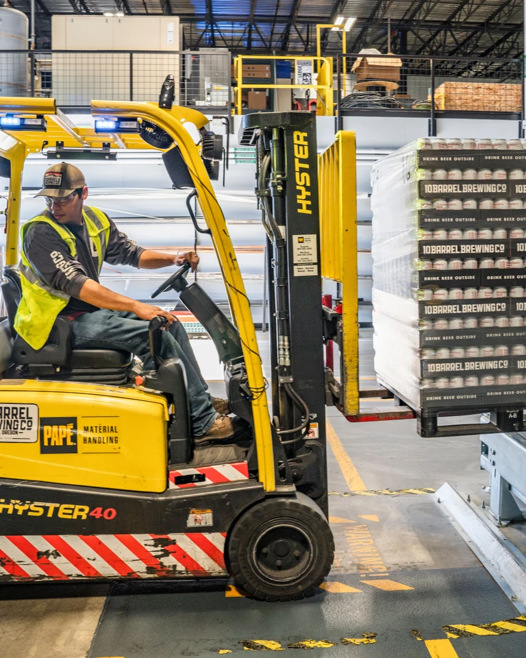A forklift operator moving warehouse goods