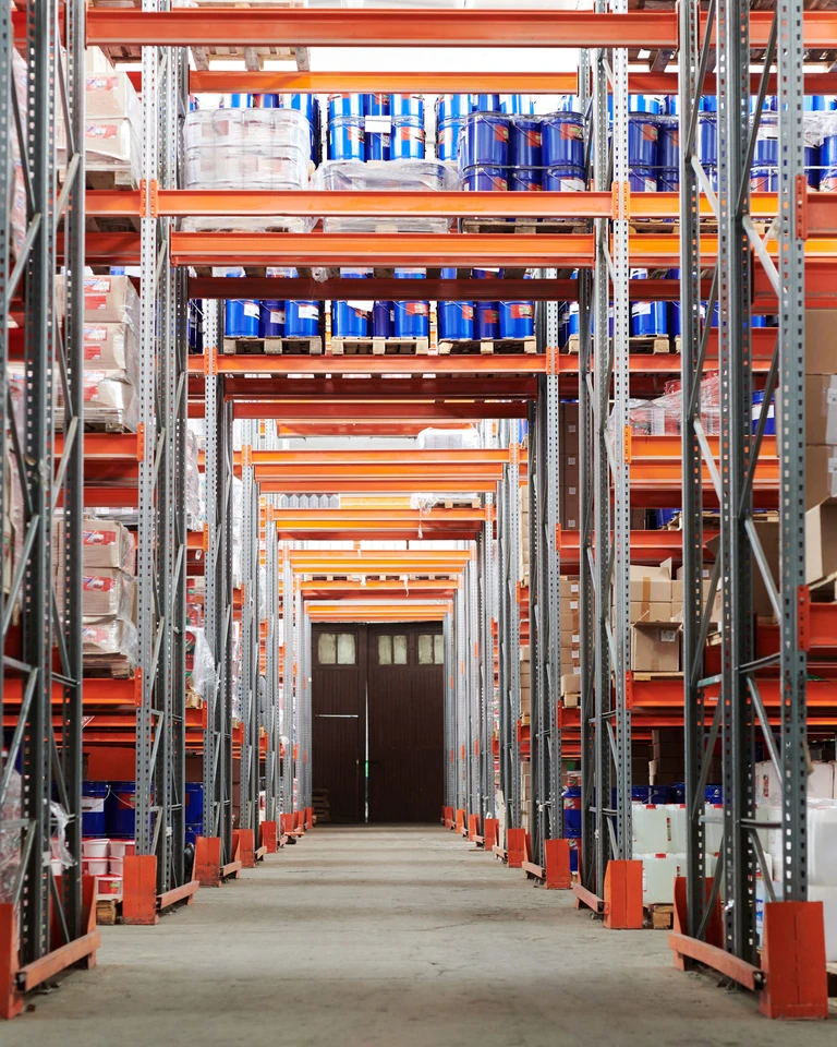 Stocked shelves along a warehouse aisle